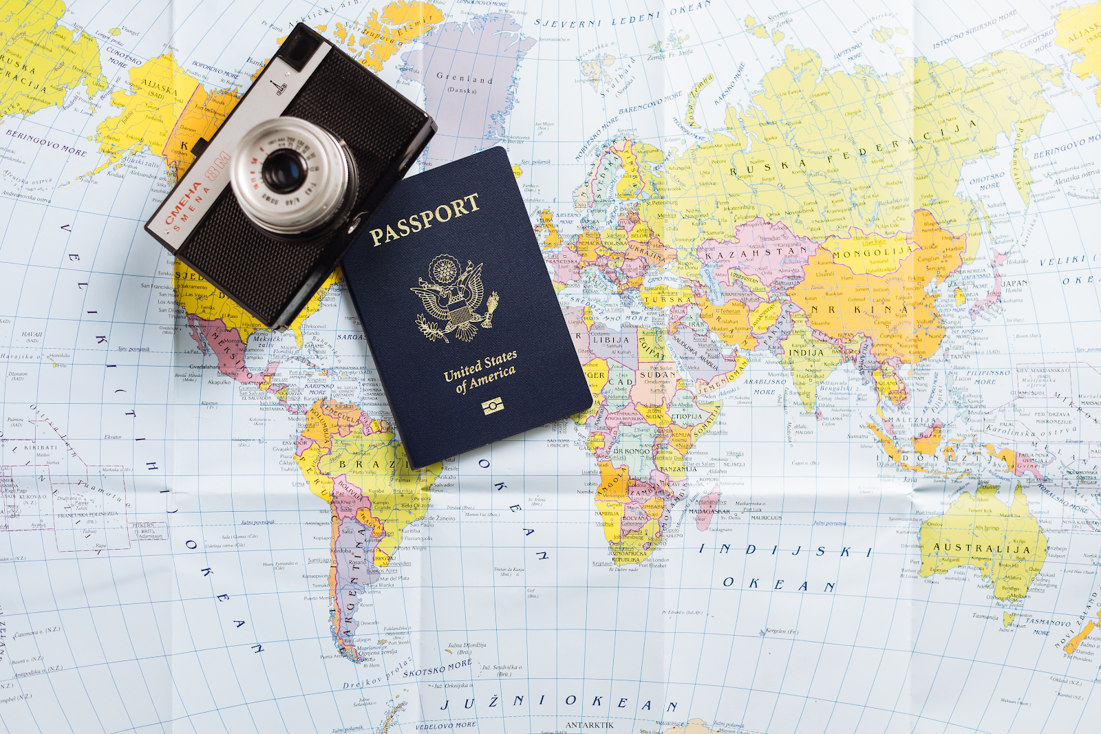 a US passport and a camera on the world map