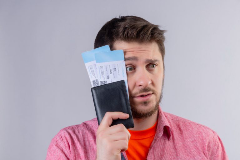 Does Costco Take Passport Photos   Young Traveler Man Holding Air Tickets Looking Aside With Confuse Expression Face Isolated White Background 768x512 