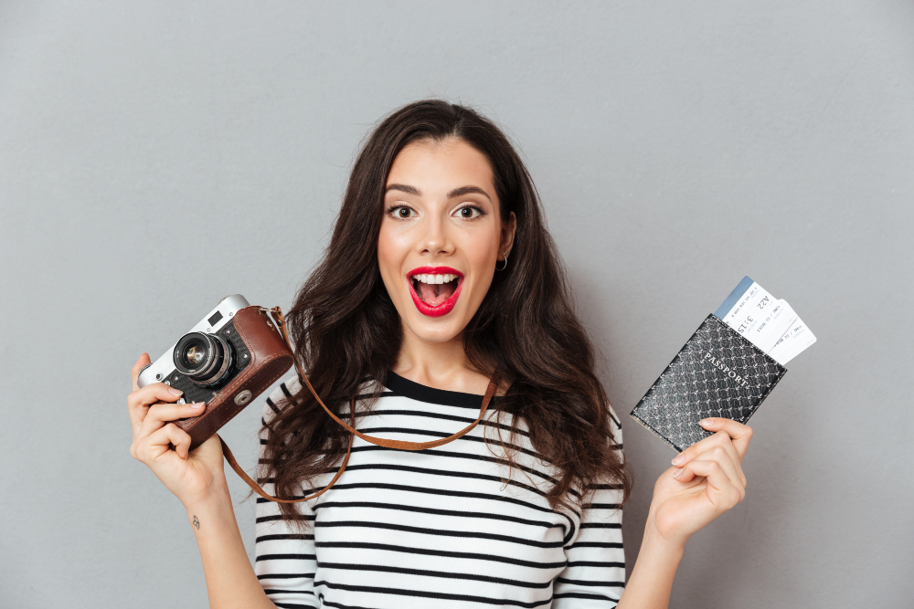 portrait of an excited woman holding vintage camera