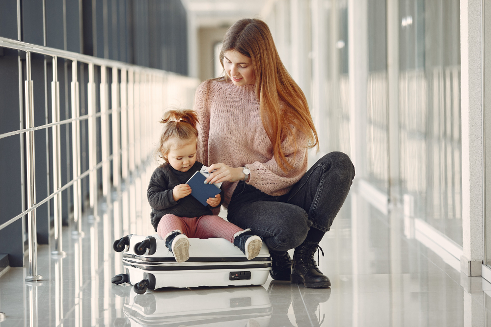 a mother and her baby at the airport holding a passport