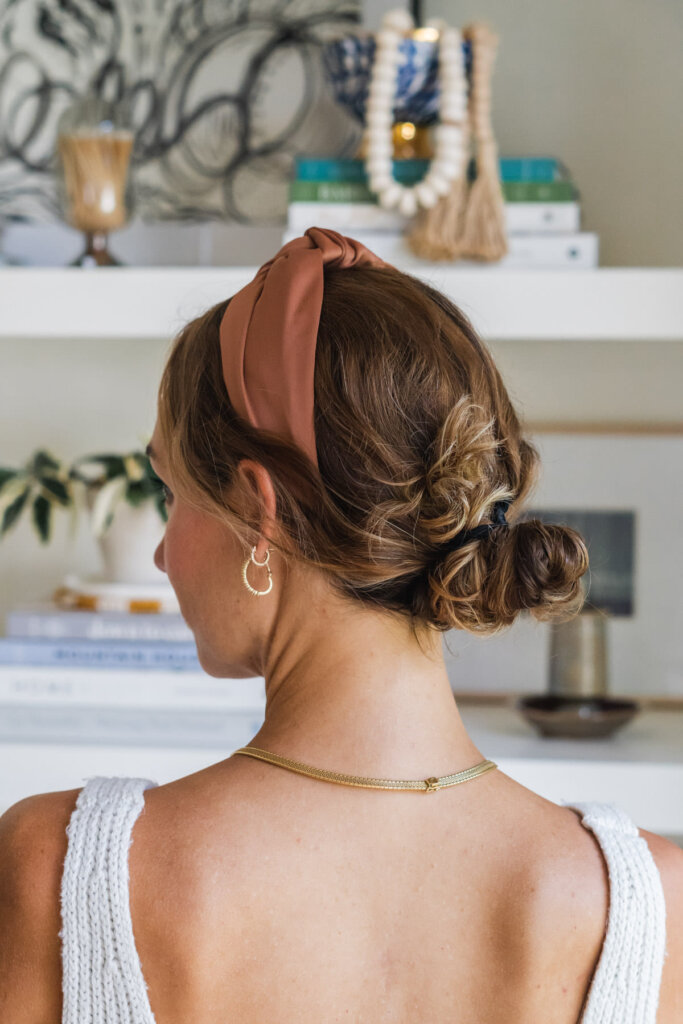 headband with slicked-back ponytails