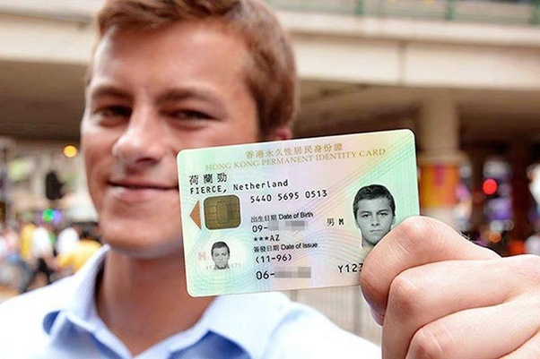 a man holding an HK ID card