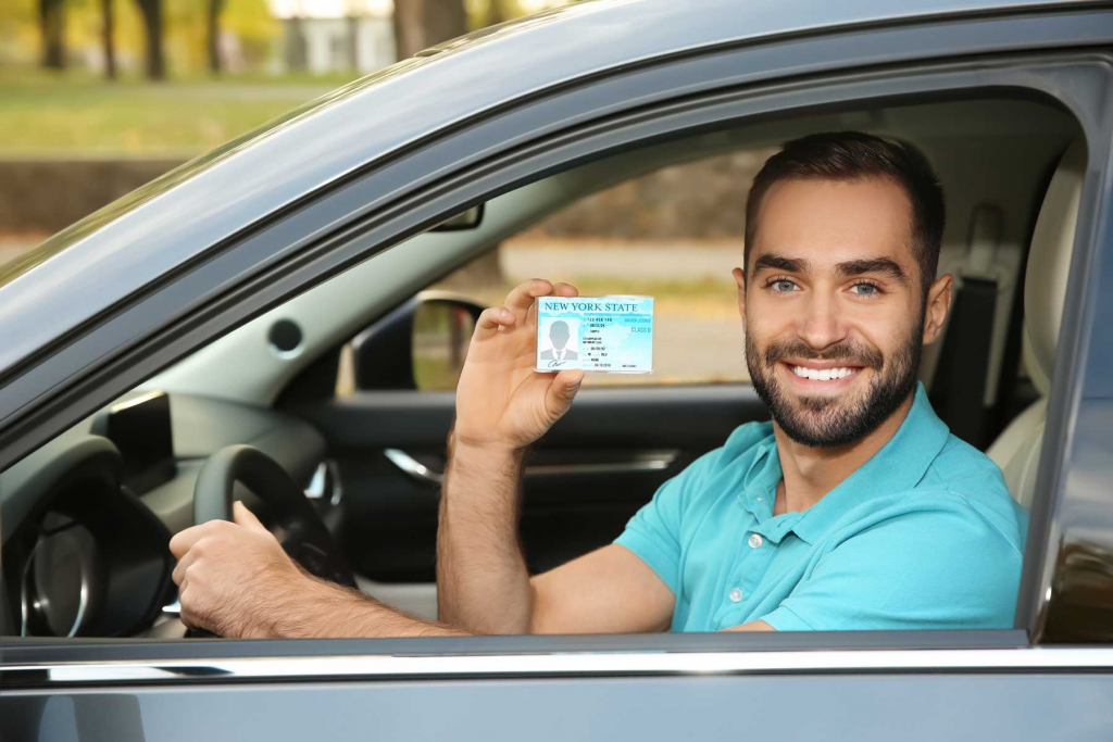 a man holding a New York driver's license