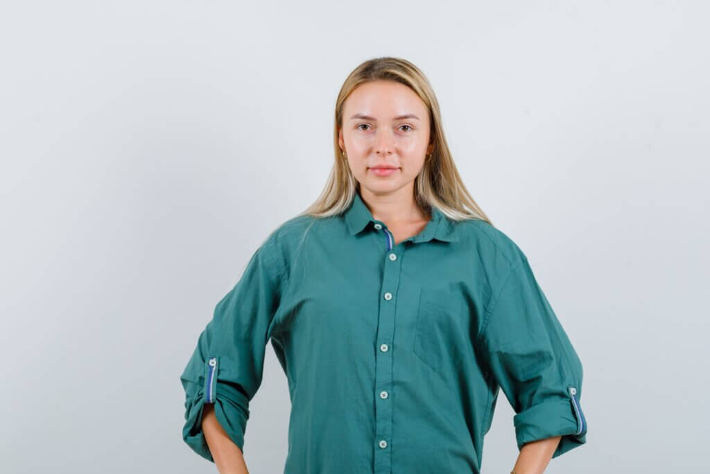 young-lady-keeping-hands-waist-green-shirt-looking-confident